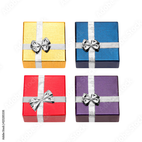Four gift boxes red, golden, purple and blue with a silver ribbon isolated on a white background
