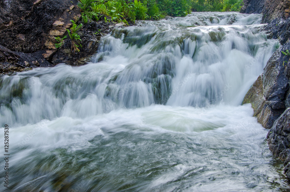 falling water in the morning mist. falling water in the morning mist.