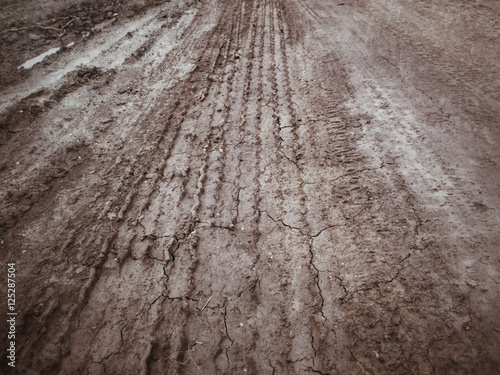 Wheel tracks on the soil.