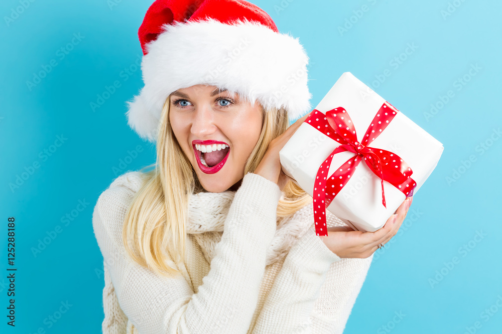 Young woman holding a Christmas gift Young woman holding a Christmas gift