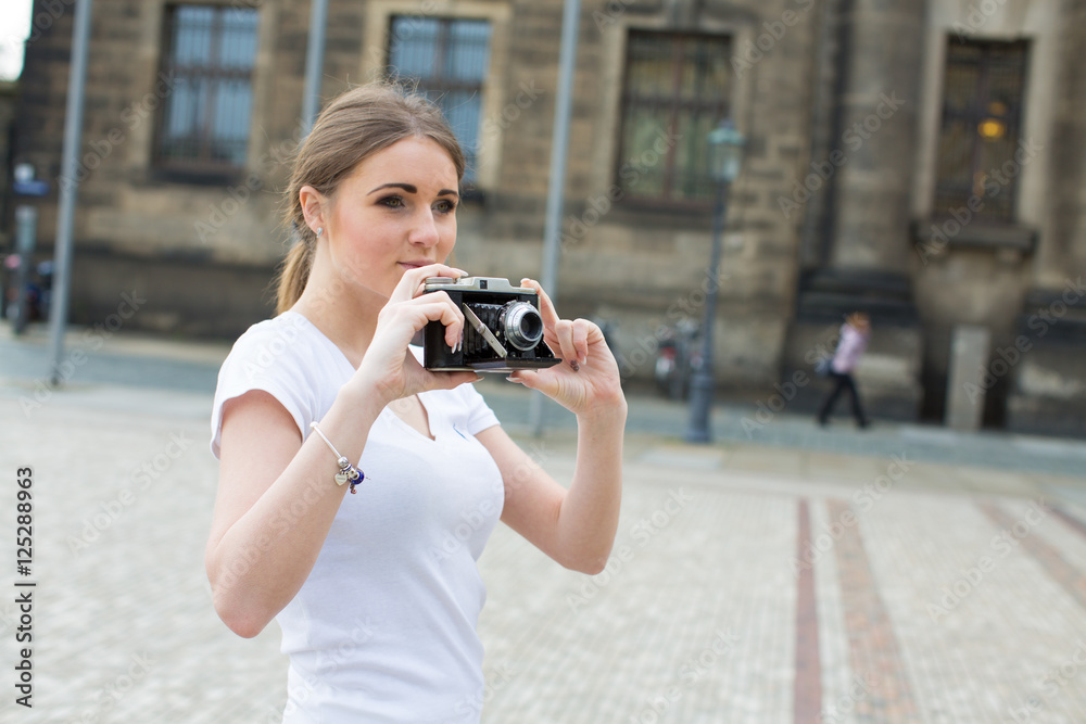 girl use retro photo camera in summer city girl use retro photo camera in summer city