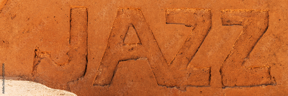 Samolepka The word Jazz photographed in sand on the beach