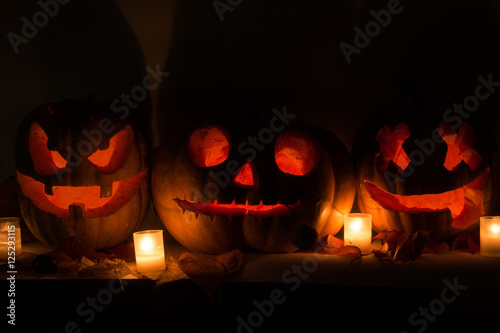Halloween pumpkins with scary face and burning candle
