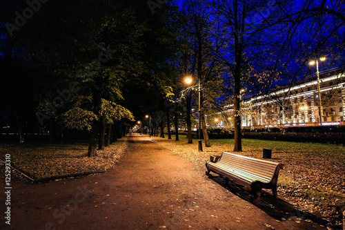 City park at twilight with bench, pathway, alley and trees autumn. Autumn park. Night park. Autumn alley.