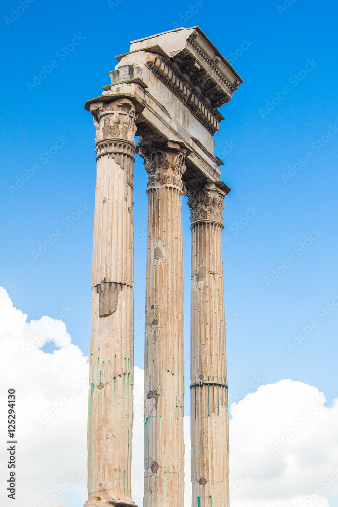      Ruins and columns of temple of Castor and Pollux in Roman Forum (Forum Romanum), blue sky in background, Rome, Italy 