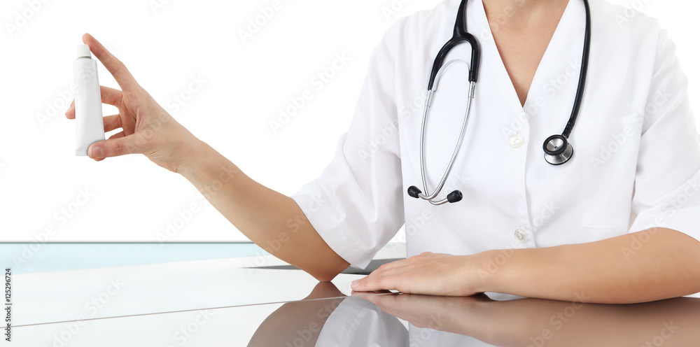 Doctor holding creme tube medicine. Health care and medical concept Doctor holding creme tube medicine. Health care and medical concept