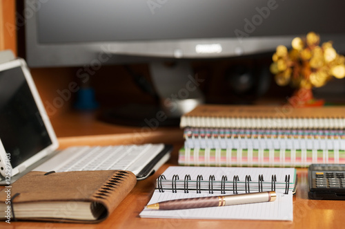 Office desk table with computer, calculator, supplies. Copy space for text