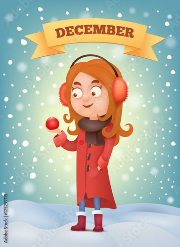 Girl in earmuffs holdin christmas ball