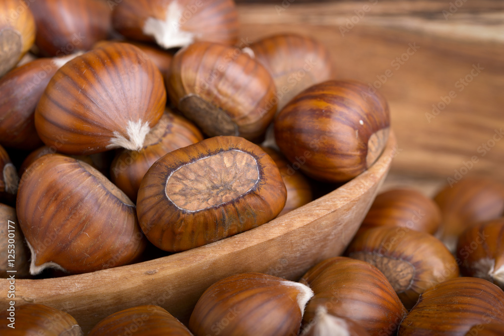 pile of chestnuts in a wooden bowl