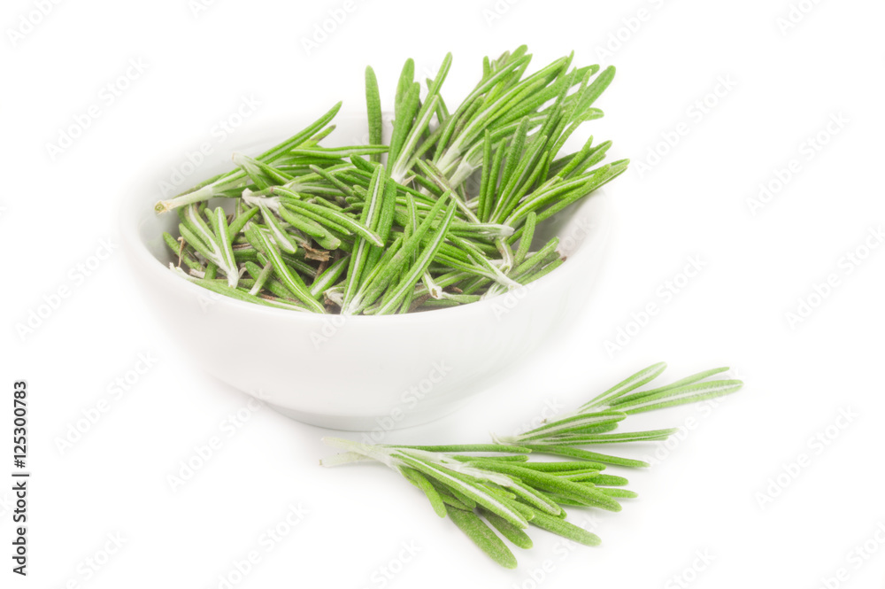 Fresh rosemary in a bowl on white Fresh rosemary in a bowl on white