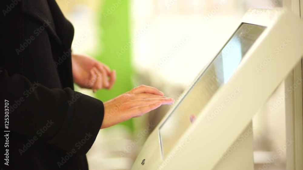 custom made wallpaper toronto digitalIn the autumn dressed woman using the self services terminal to pay on the fare.