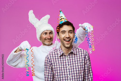 Drunk man and rabbit at birthday party over purple background.