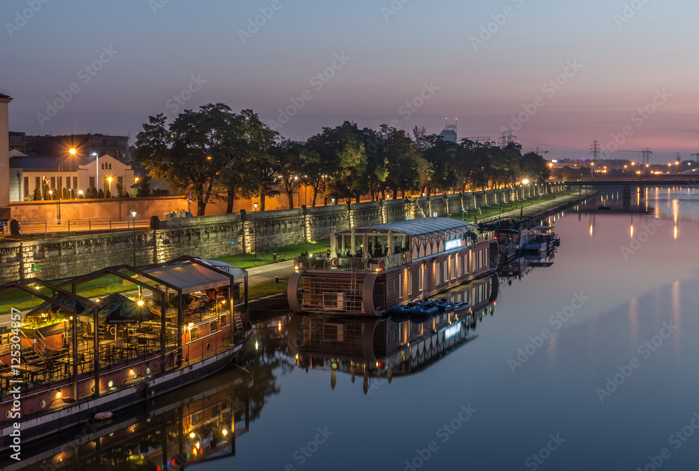 Vistula boulevards in the morning in Krakow, Kazimierz district with moored ships