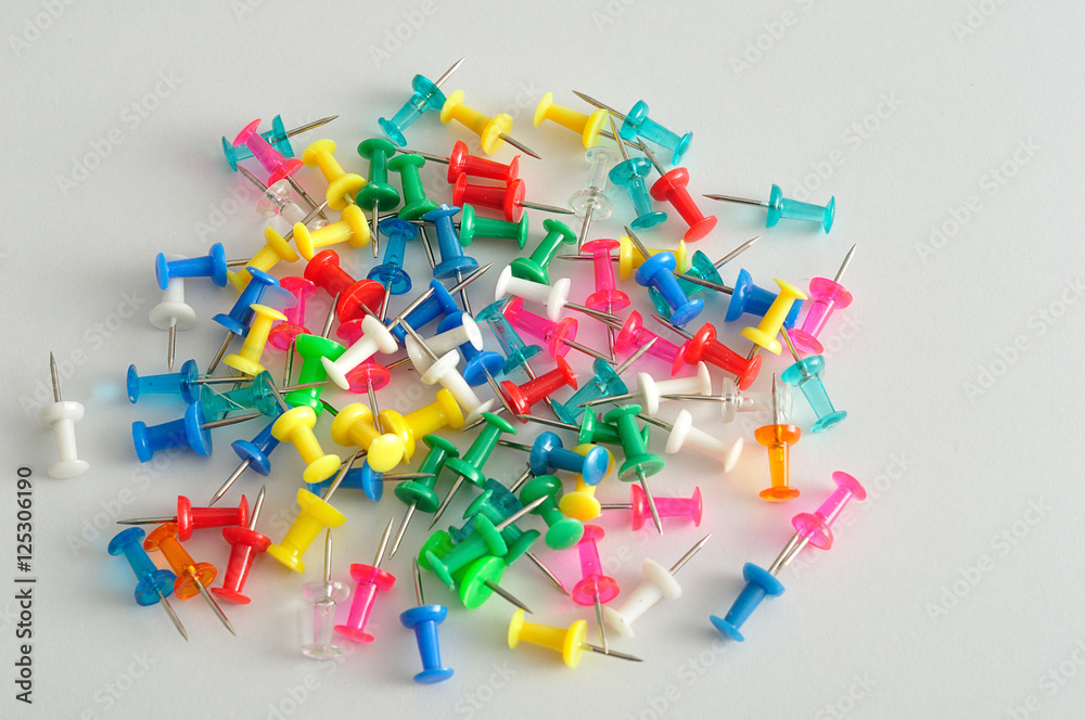 Colorful push pins displayed on a white background Colorful push pins displayed on a white background