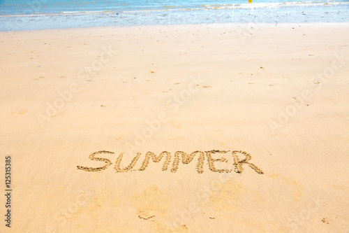 Summer word written on sand