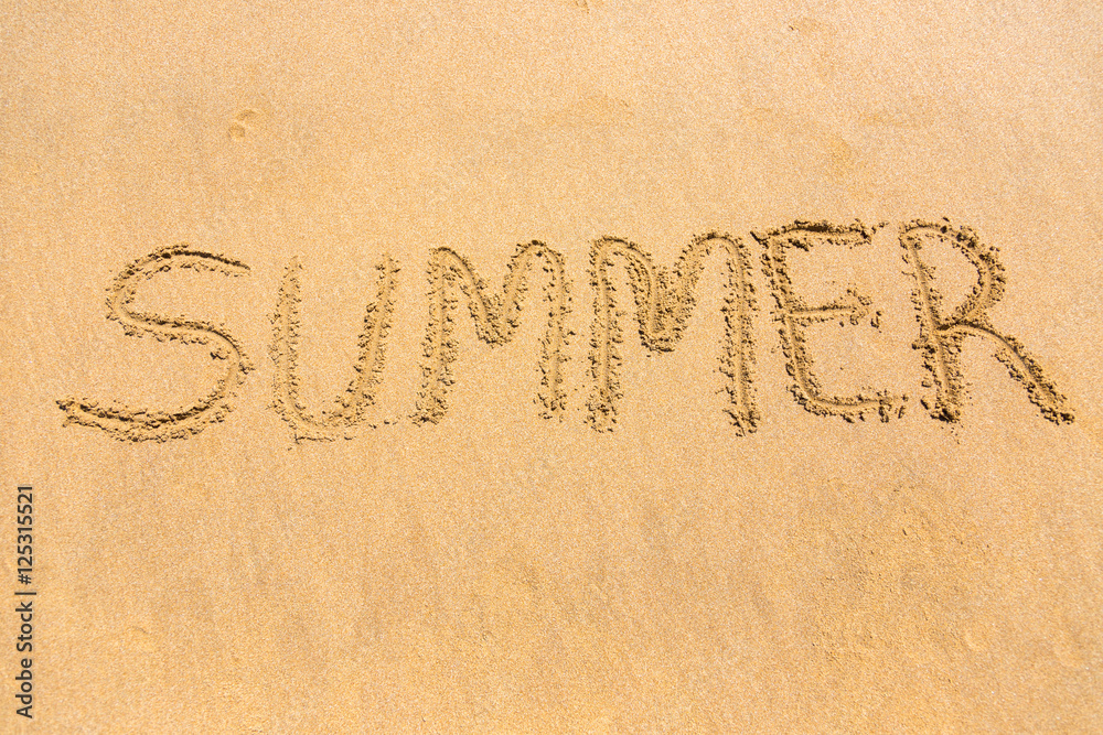 Summer word written on beach sand Summer word written on beach sand