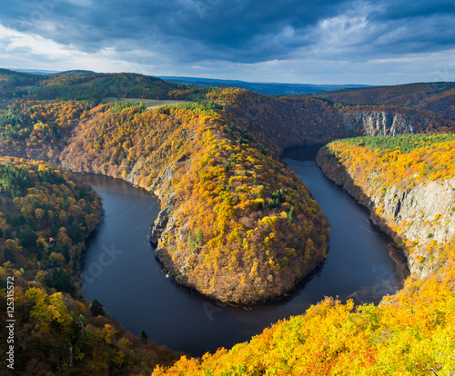 River canyon with dark water and autumn colorful forest. Horseshoe bend, Vltava river, Czech republic. Beautiful landscape with river. Maj lookout.