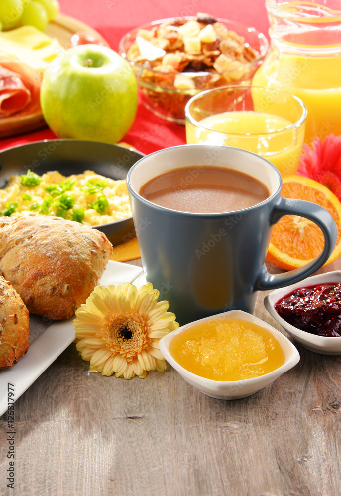 Breakfast served with coffee, juice, egg, and rolls Breakfast served with coffee, juice, egg, and rolls