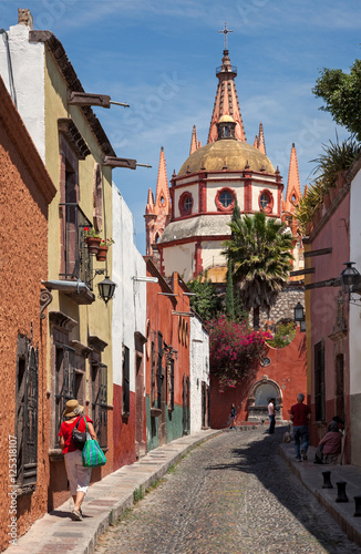 Beautiful Alley with Colorful Buildings Leading To Parroquia de San Miguel Arcangel church in Mexico photo