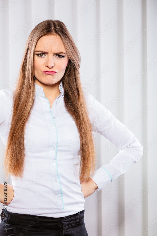 Angry and irritated business woman in office.
