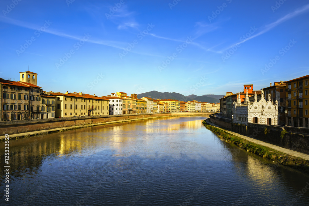 Pisa, Arno river sunset. Lungarno and Spina small church. Italy