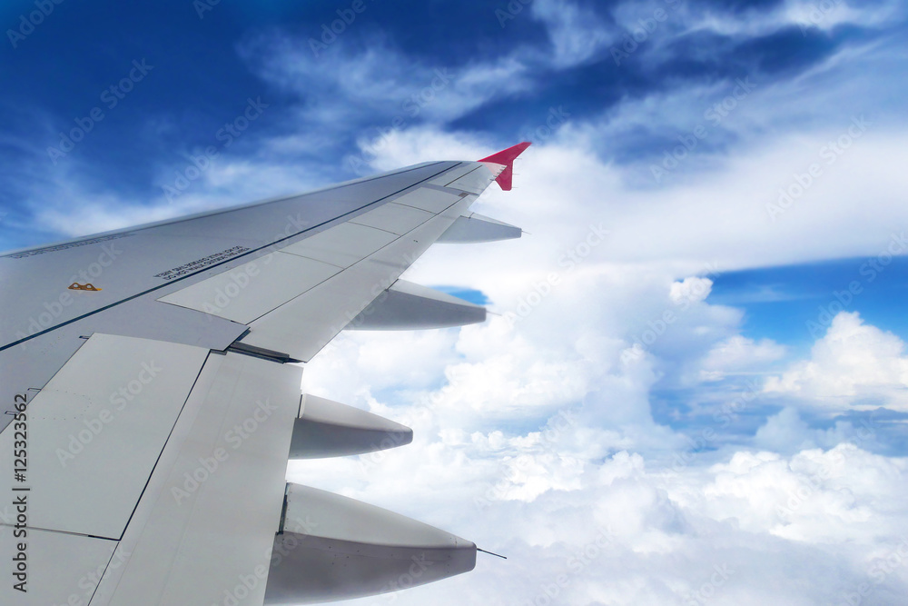 Fototapeta premium Looking through window aircraft during flight in wing with a nice blue sky