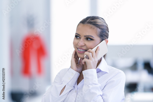Young woman with mobile phone in the office