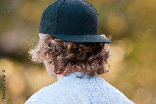 Teen with backwards hat photo