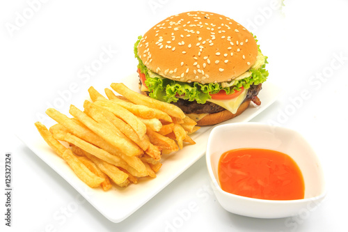 tasty hamburger, French fries and chili sauce on white plate, Fast food with copy space