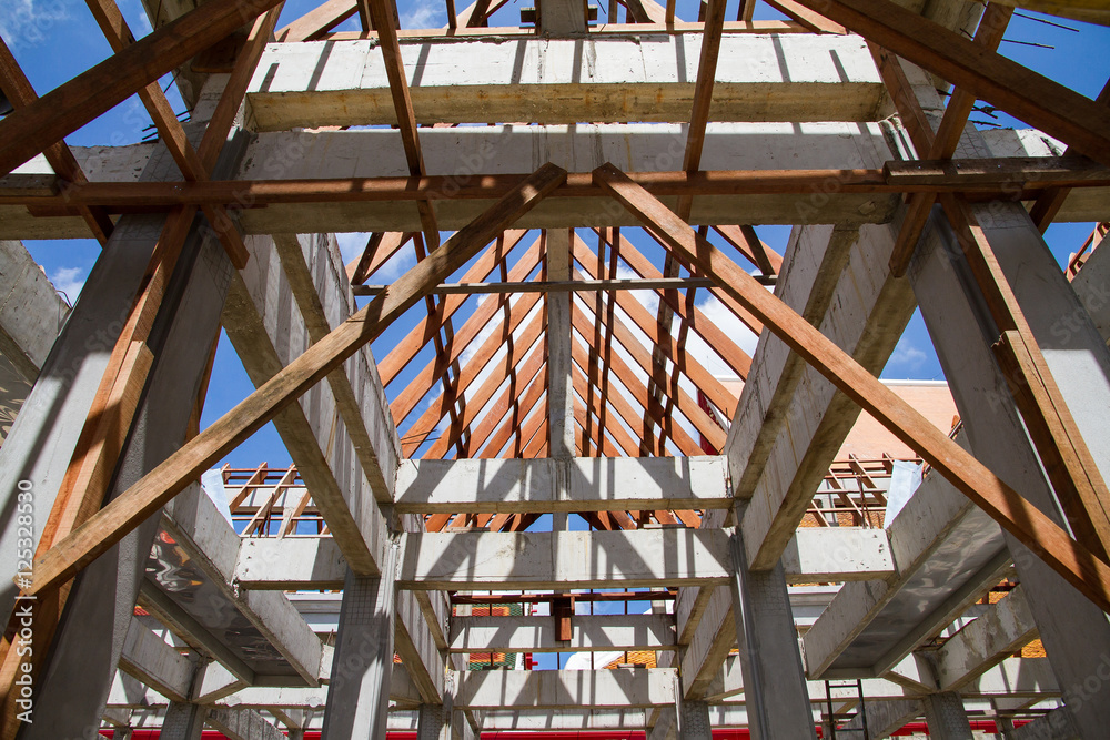 Low angle view of roof trusses and framing wooden of new house c Low angle view of roof trusses and framing wooden of new house c