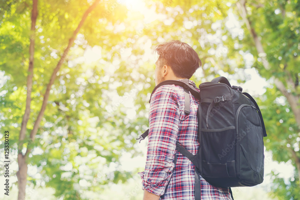 Side of hipster young traveler man looking to the nature, enjoyi Side of hipster young traveler man looking to the nature, enjoyi