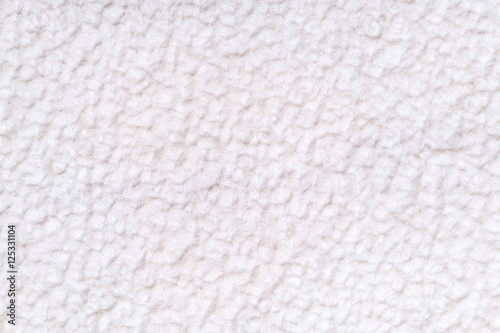 White fluffy background of soft, fleecy cloth. Texture of textile closeup.