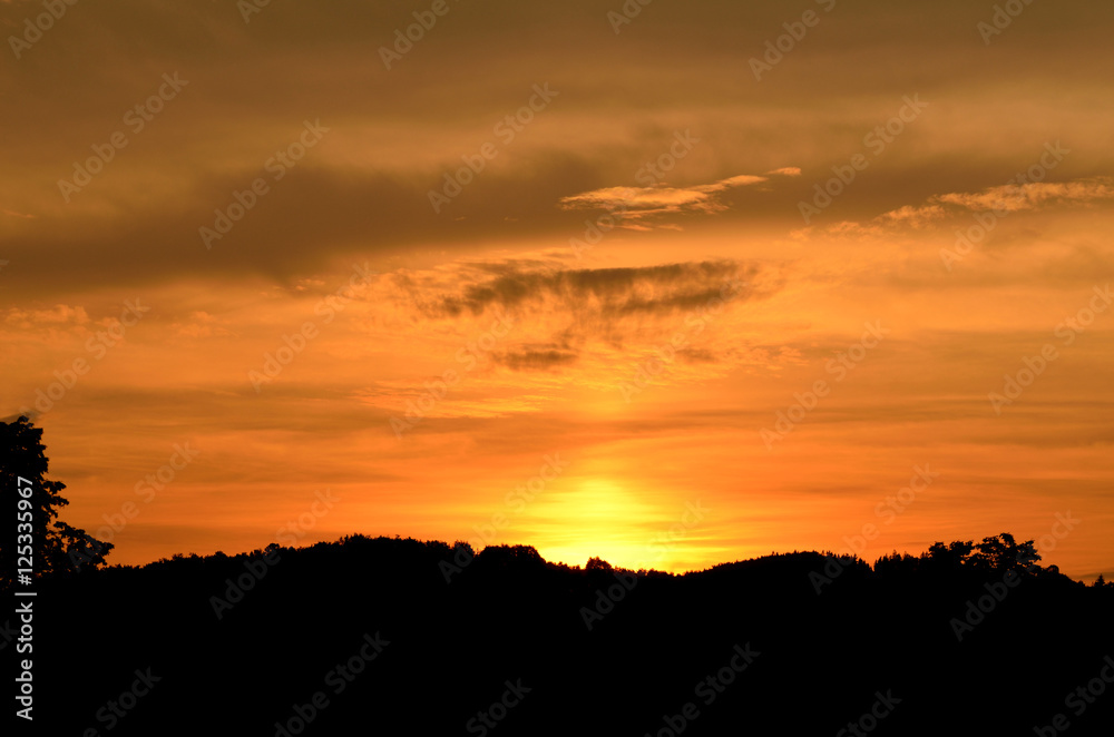 Beautiful orange sunset over the silhouetted mountains