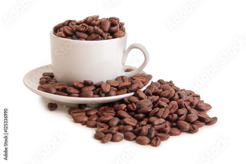 Coffee beans and a white cup on white background