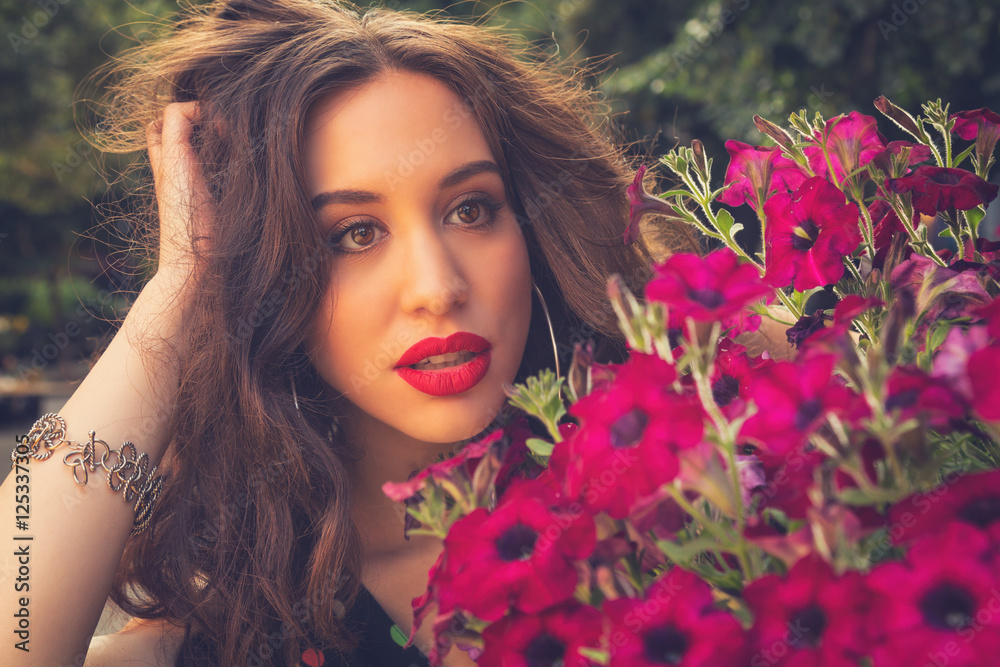 Naklejka premium Portrait of a girl with flowers.