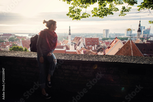 woman hiker looking at the city from high photo