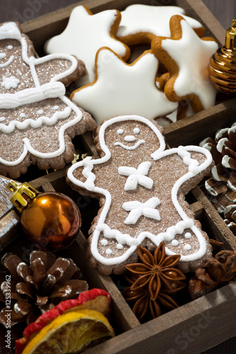 Christmas symbols and cookies in a wooden box, top view