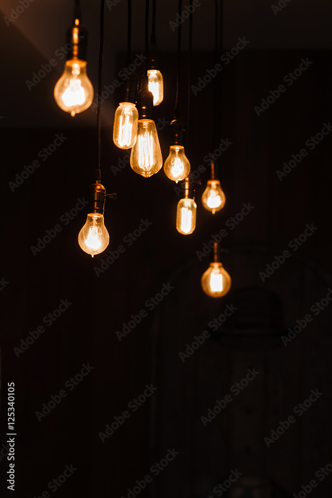 Incandescent lamps in a modern loft. Edison lamp composition on dark background, free space for text or advertisement. Teamwork, idea, creativity, light concept