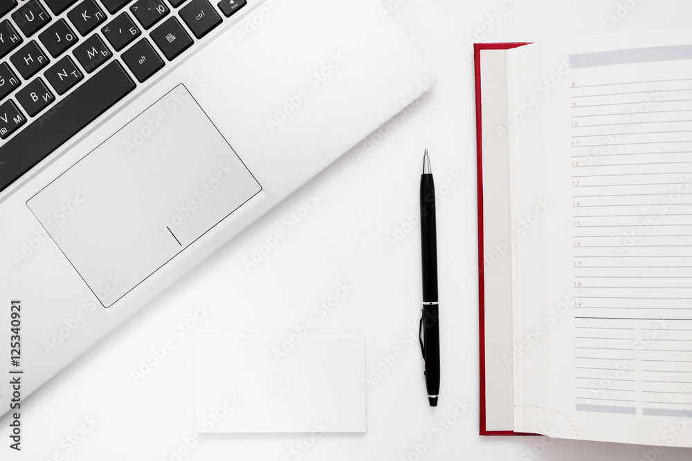 Laptop keyboard, pen and notebook flat lay. Top view on successful businessman work accessories, free space. Laptop keyboard, pen and notebook flat lay. Top view on successful businessman work accessories, free space.