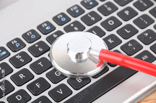 Keyboard and stethoscope and medical records, medical concept photo