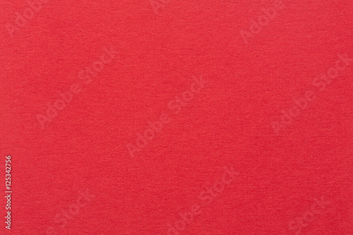 A red paper background with mottled texture.