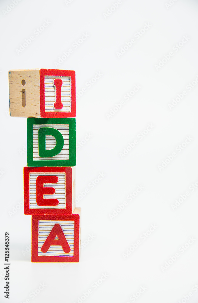 IDEA word wooden block arrange in vertical style on white background and selective focus IDEA word wooden block arrange in vertical style on white background and selective focus