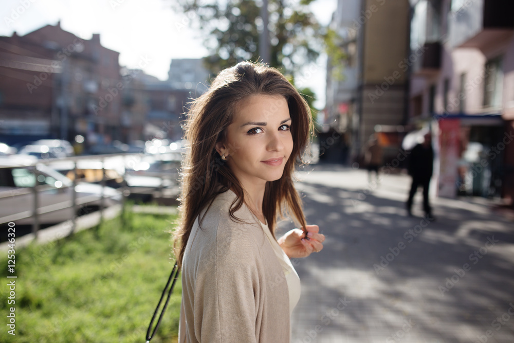 Fototapeta premium Outdoor portrait of beauty woman with perfect smile walking on the street