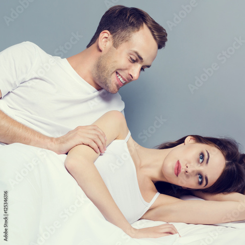 Unhappy young couple on the bed photo