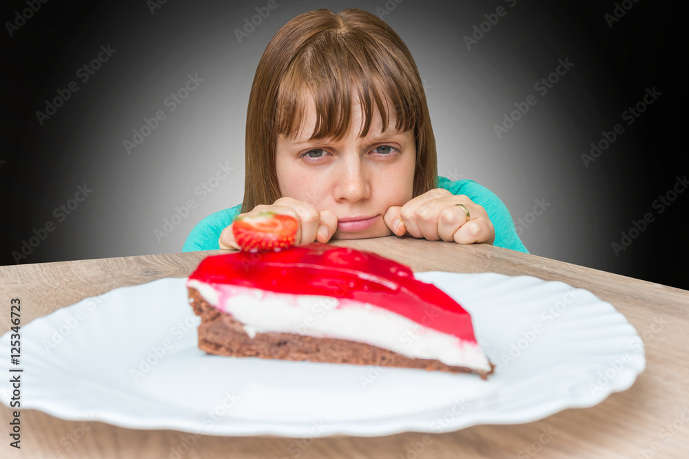 Woman cannot resist the temptation and wants to eat sweet cake
