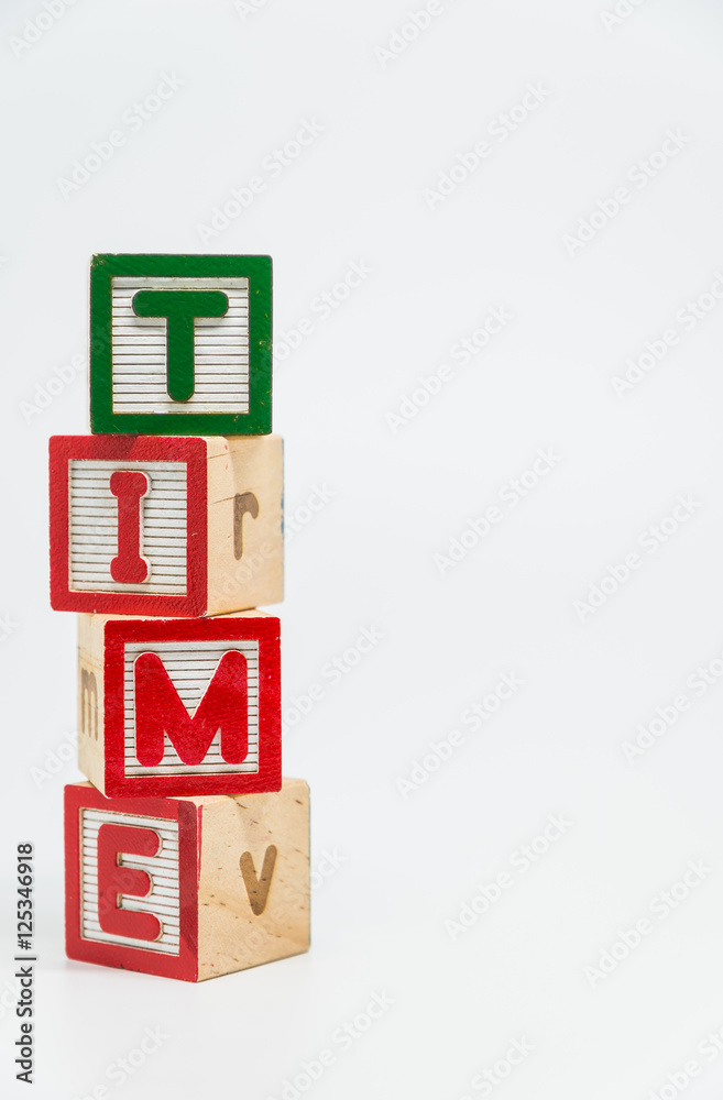 TIME word wooden block arrange in vertical style on white background and selective focus TIME word wooden block arrange in vertical style on white background and selective focus