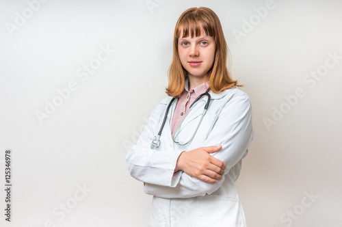 Portrait of young woman doctor with arms crossed