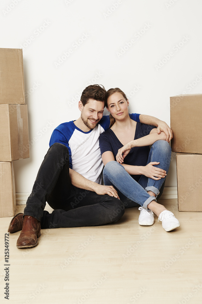 Couple moving home with cardboard boxes, portrait Couple moving home with cardboard boxes, portrait