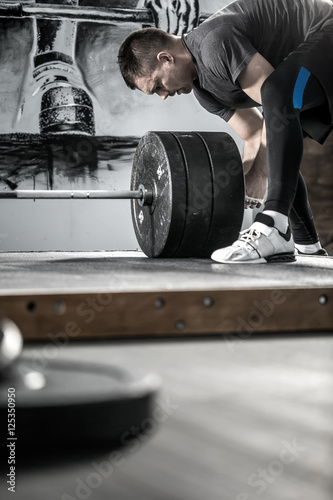 Preparation of barbell in gym