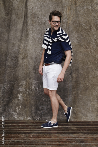 Smiling man in shorts and striped sweater